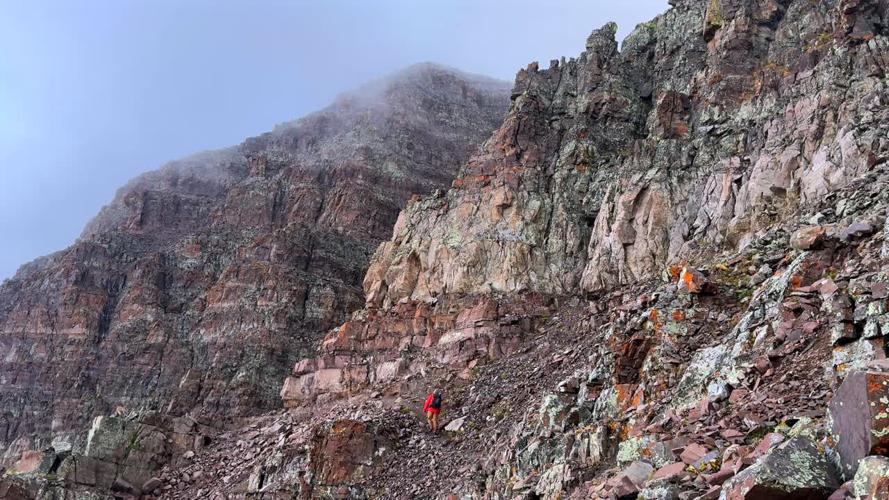 Backside Maroon Peak hiking trail up fourteener rugged mountain terrain Bells Wilderness Colorado summer clouds dense fog movement Aspen Snowmass Elk Range Rocky Mountains static shot