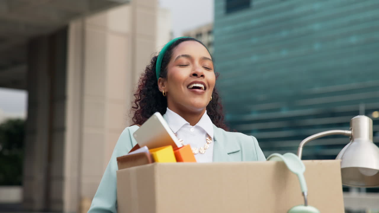 Woman leaving office with cardboard box