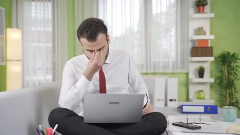 businessman with sore eyes taking a break and resting his eyes.