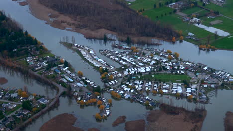 high aerial shot of flooded trailer park next to river, vancouver area