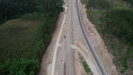 reveal vast rail construction site, building sustainable railway infrastructure, aerial