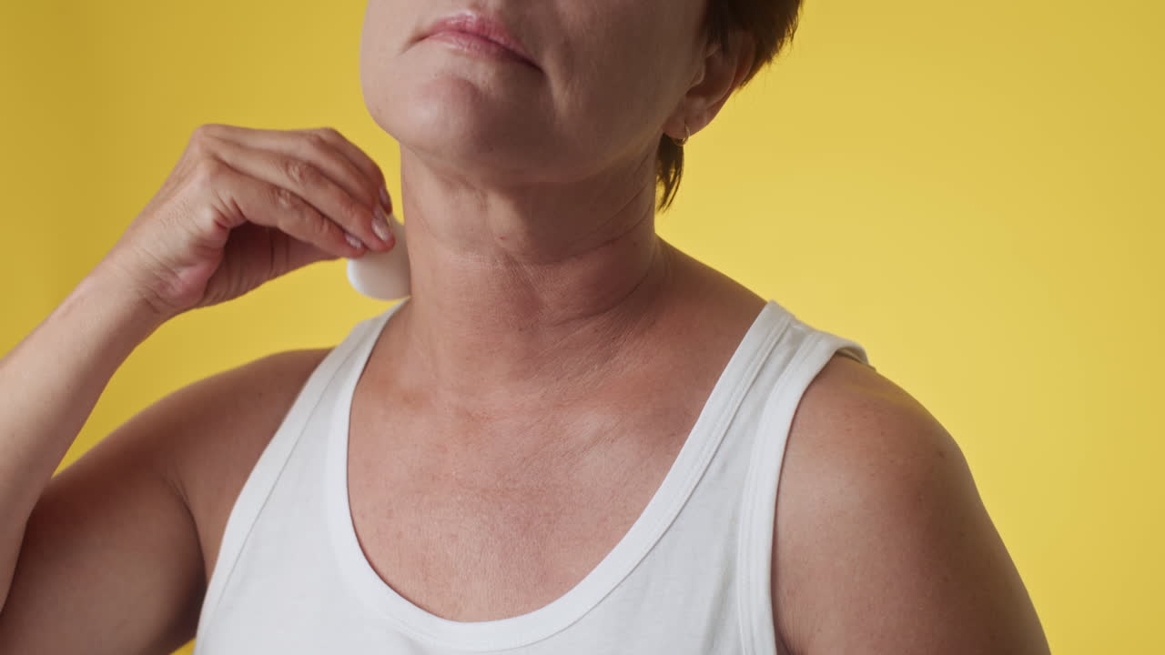 Woman Doing Anti-age Neck Massage with Gua Sha
