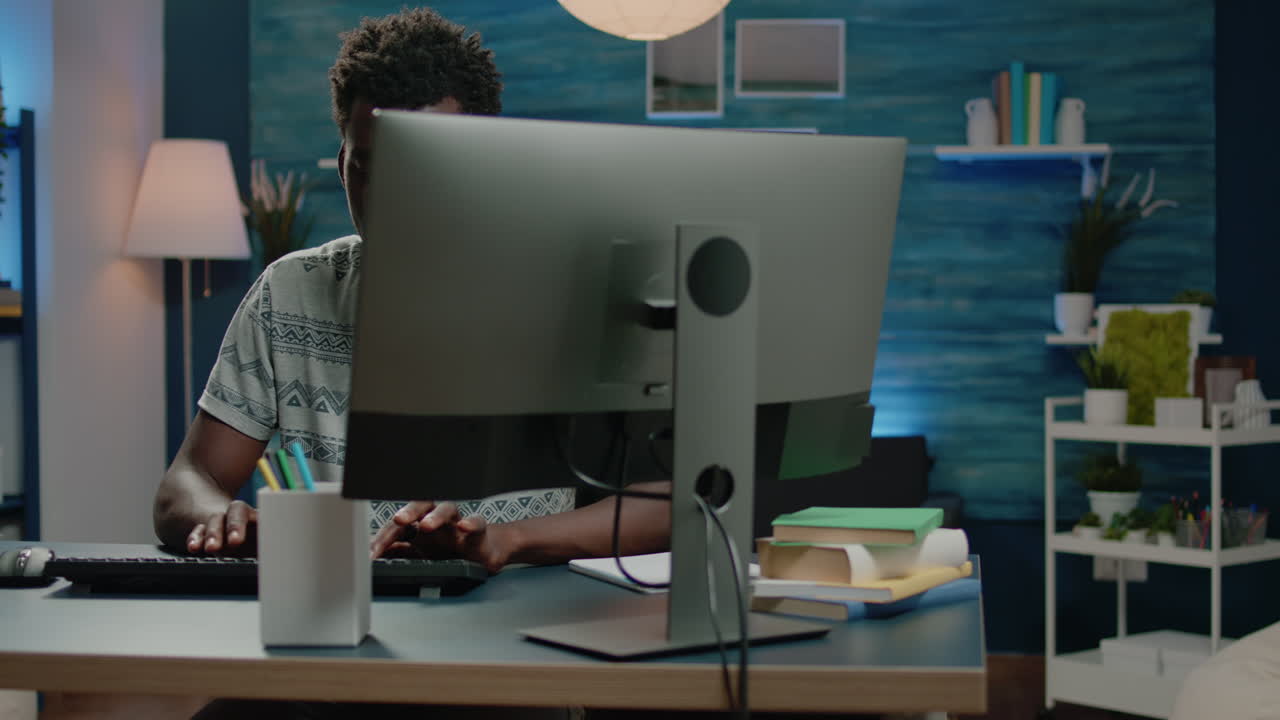 Adult of african ethnicity using computer for remote work