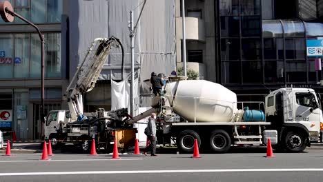 concrete mixer truck operating with extended boom