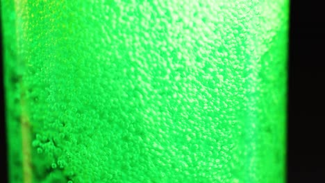 bubbles rising in a green fizzy drink