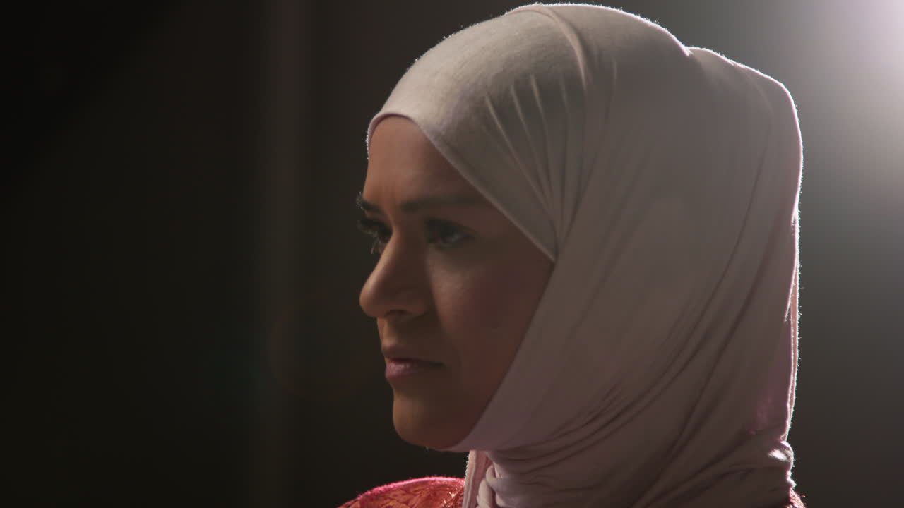 평평한 배경에 히자브를 입은 무슬림 여성의 스튜디오 초상화 1