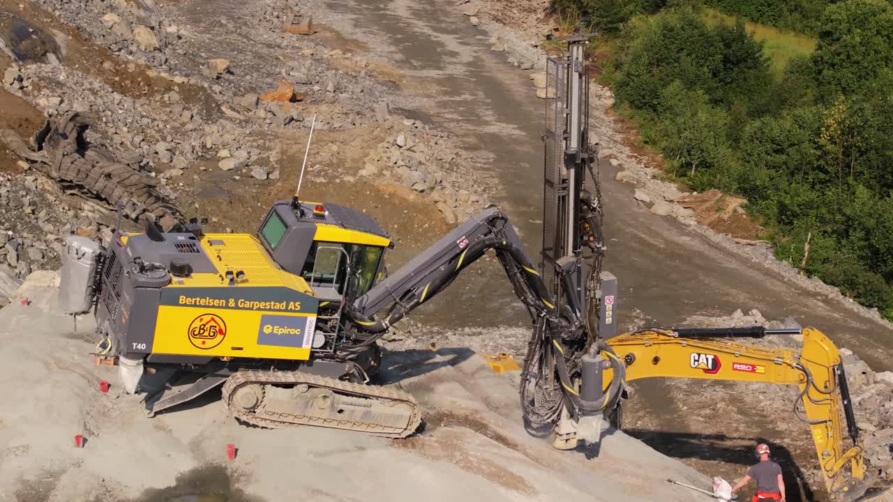 Aerial Establishing Shot of Drill Rig with Excavator Digging in Background