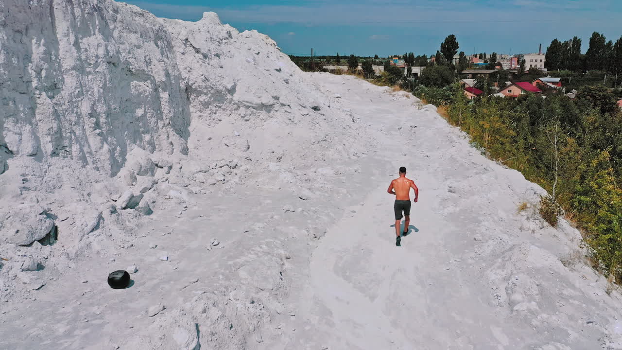 Sportive man training outdoors. Running athlete man training cardio on mountain