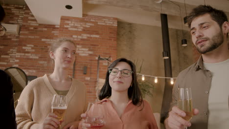 a multiethnic group of friends toasting with their glasses at a dinner party 1