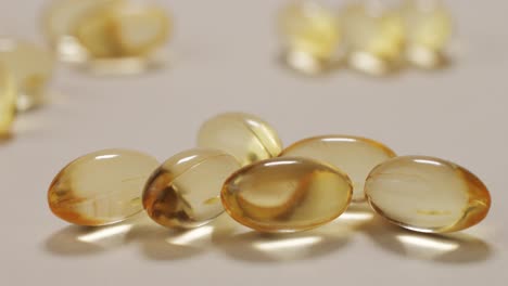 omega fish oil pills dietary supplement falling down on white background. omega fish oil softgels dietary supplement background. healthy life and heart health concept.