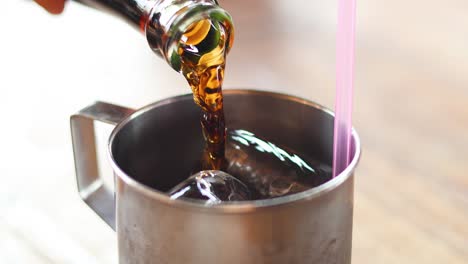 sequence of pouring a beverage over ice cubes