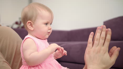 dad with baby playing hands