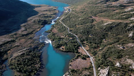 tracking shot of a beautiful green landscape with a river running through it