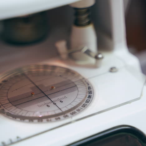 Optician making new lens for eyeglasses. Modern equipment for glasses production in the lab. Close-up.