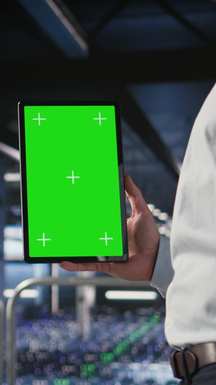 Vertical video Close up of data center admin using mockup tablet to update software