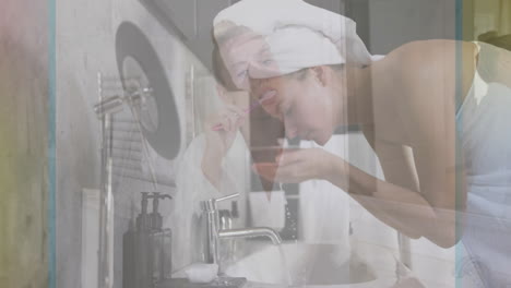 brushing teeth and washing face, woman using towel at bathroom sink