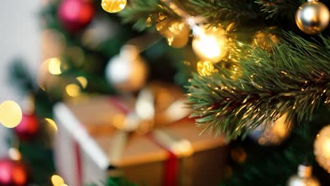 closeup of a christmas tree decorated with ornaments, lights, and gifts