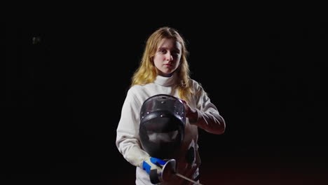 woman in white fencing uniform practicing with a foil