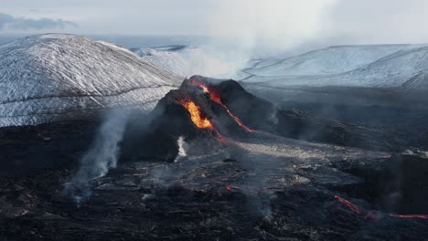 Aerial-at-active-volcano-in-Iceland-valley-spewing-lava,-spatter-cone