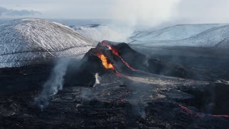 aerial at active volcano in iceland valley spewing lava, spatter cone