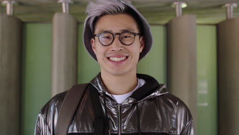 portrait of young asian man student smiling confident proud wearing glasses hat