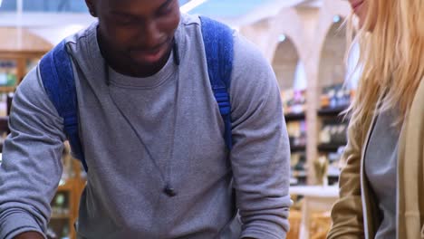 engaging shopping experience: two friends explore wine selection and prepare for checkout at their local grocery store with enthusiasm and curiosity