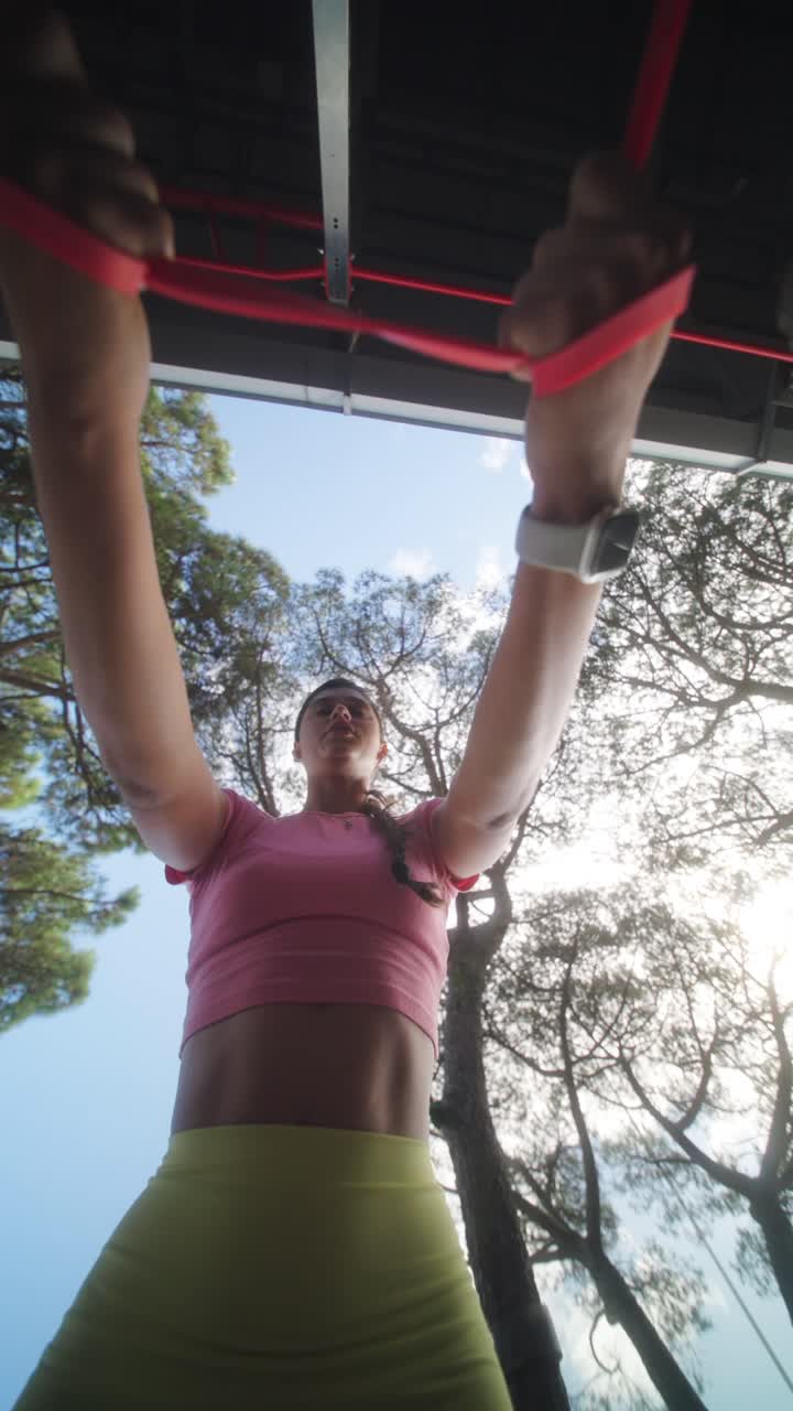 Woman working out with resistance bands outdoors