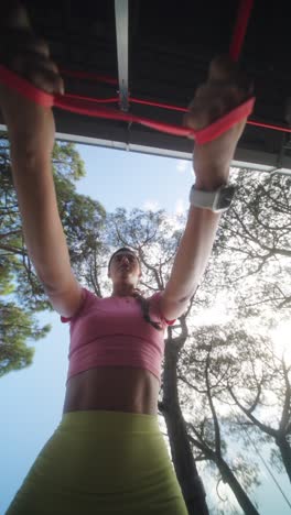 woman working out with resistance bands outdoors