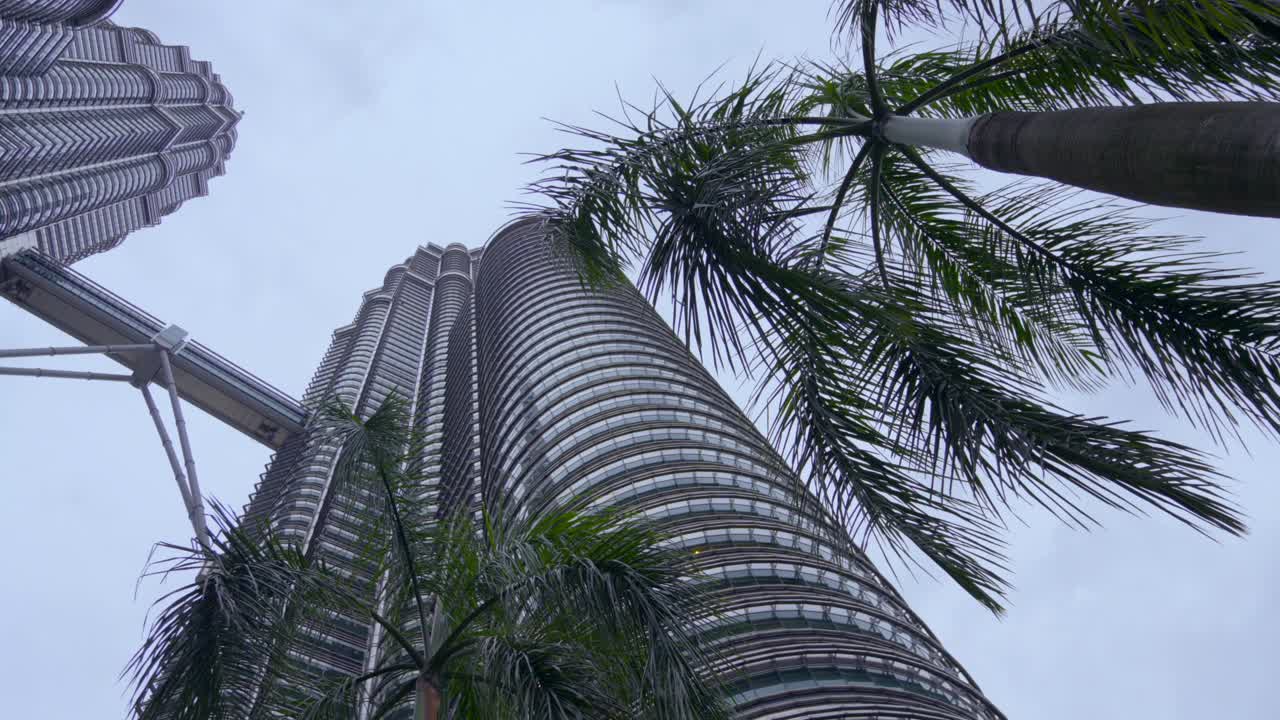 Bottom view of Twin Towers Menara Berkembar Petronas Kuala Lumpur Malaysia Palms