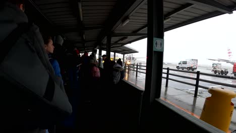 People-queueing-to-board-the-commercial-flight-of-Ryanair-at-outside-terminal-at-Brussels-International-Airport---Belgium