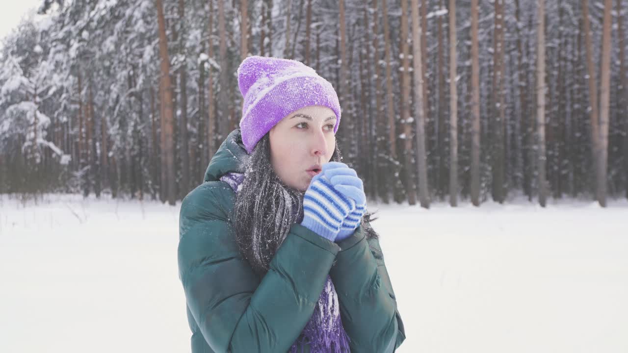 a lonely girl in the woods freezes, covered with snow after a snow storm