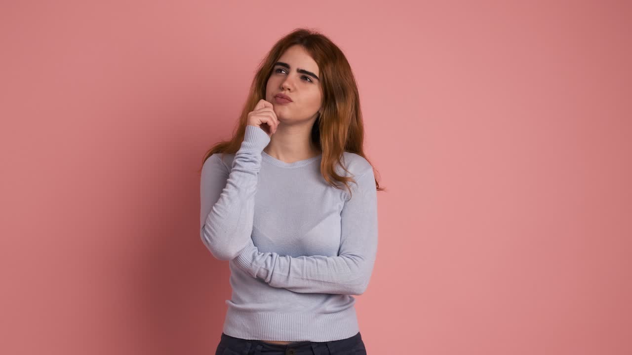 A pensive woman gesturing hand on chin