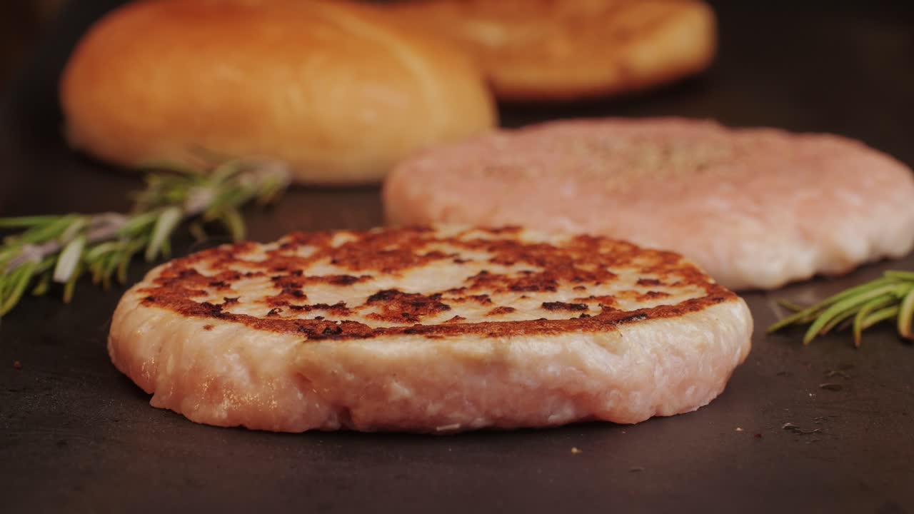 Cooking American fat smash burger on grill close-up. Chicken or fish cutlet smashing by burger press. The chef in kitchen of the restaurant making cutlets for burgers - smash burger beefsteak. Fast and street food concept. High quality 4k footage