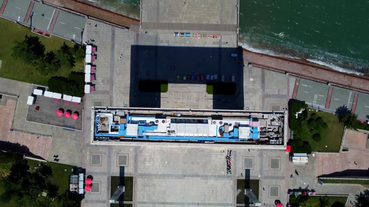 Aerial bird's eye view of Xingfu park modern tall arch glass building - Weihai China