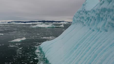 scenic footage captures glaciers floating on serene frozen lake during daytime in iceland, showcasing pristine beauty of icy formations amidst tranquil wintry landscape