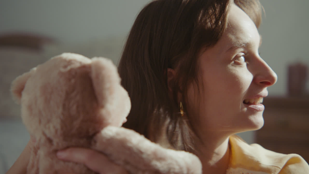A girl playing with dolls in her room