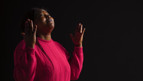 woman praying with palms extended upward