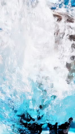 happy boy swimming and splashing in a pool