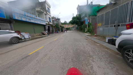 motorcycle driving on the city road of ha giang province in northern vietnam. pov shot
