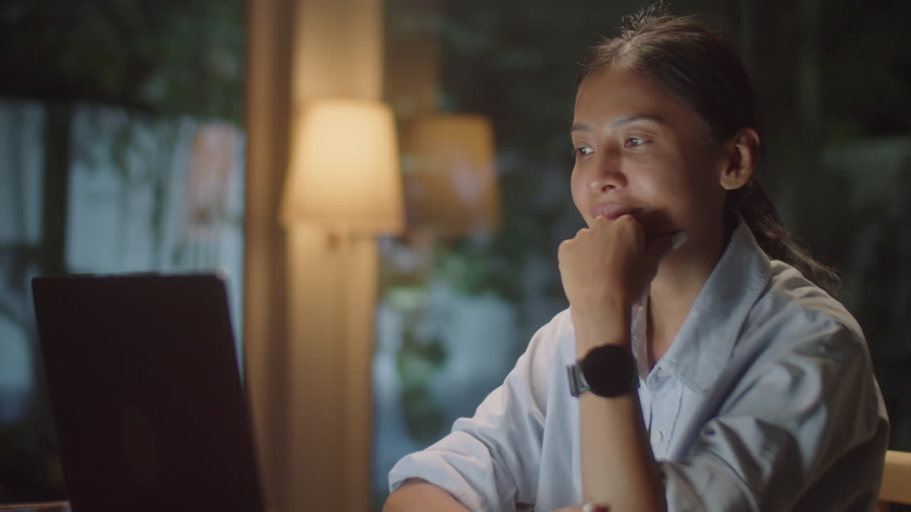 Asian Woman Chatting on Video Call in Evening