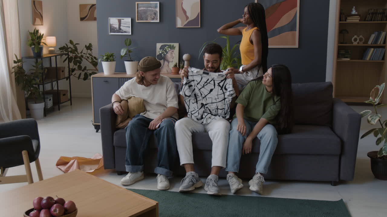 Diverse group of friends socializing and having fun on a couch in a living room