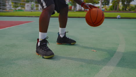 young boy dribbling a basketball on a court