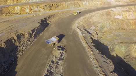 Heavy-machinery-working-in-te-riotinto-open-pit-copper-mine-aerial-shot