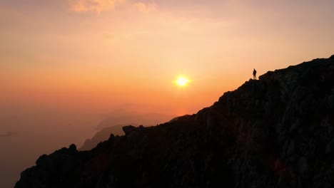 a guy is enjoying the view from the top of the mountains