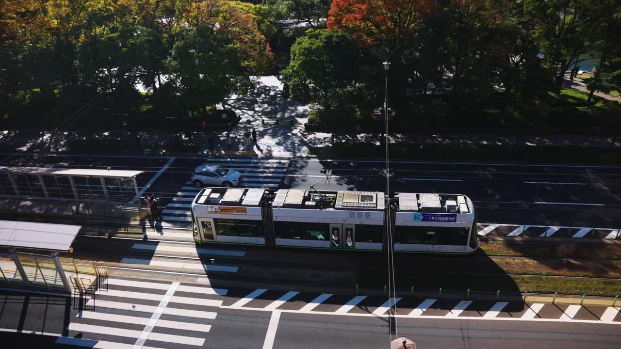 Streetcar in Hiroshima Departing from Atomic Dome Station on Sunny Fall Day