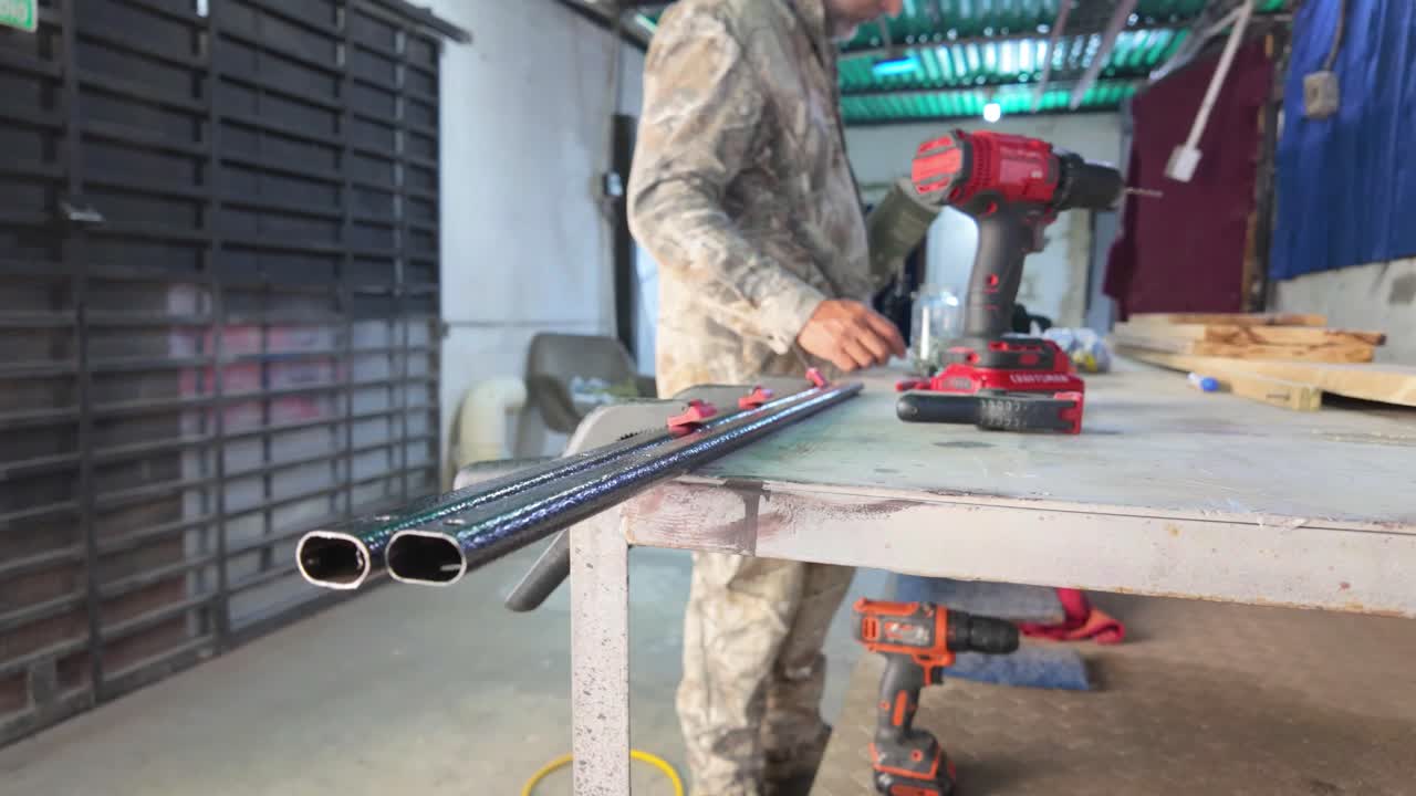 Working labour. Man arranging tools on workshop workbench.