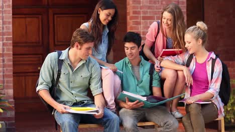 Happy-students-chatting-together-outside