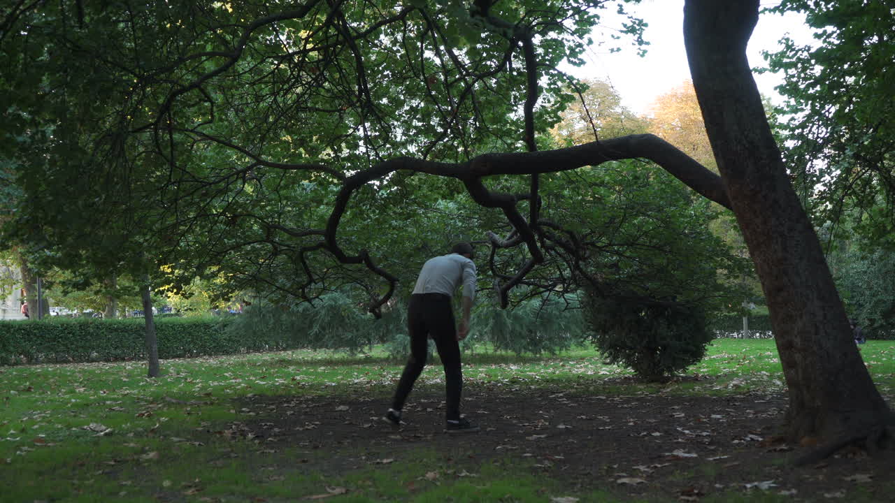 Break dancer practising tricks in the park. On sunset