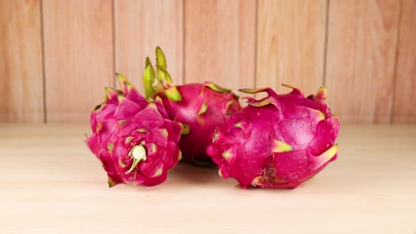 frutas de dragón dispuestas en una mesa de madera
