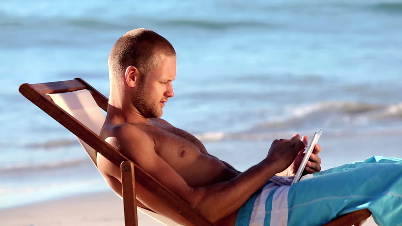 Handsome man sitting on the beach